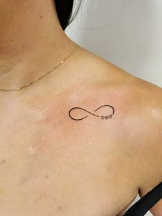 a woman with a tattoo on her chest that has an infinite symbol in the middle