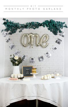 a white table topped with cake and balloons