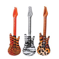 three guitars are lined up in the shape of zebras and giraffes