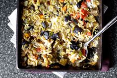 a close up of a plate of food with rice and olives on the side