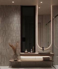 a bathroom with a sink, mirror and lights on the wall above it's counter