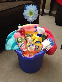 a blue bucket filled with cleaning products on top of a carpet