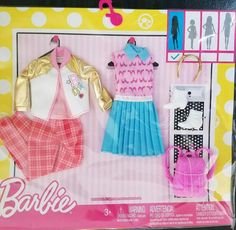 the barbie doll is in its box and it has clothes on display with other accessories