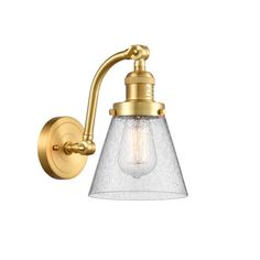 an antique brass wall light with clear glass shade