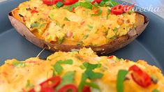 an omelet is sitting on top of a blue plate with green and red toppings