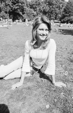 a woman laying on the ground with her legs crossed