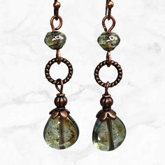 Earthy green teardrop earrings made of glass with subtle luster and copper metal accents. Beautifully colored beads, shades of forest green and brown mix with a Picasso finish. Enjoy the fresh look of these unique green bead earrings that will remind you of the forest and add an organic natural look to your outfit.  Easily go from day to evening with these versatile, Boho beaded earrings that were inspired by nature. - Hypoallergenic ear wires (nickel and lead free). Select ear wire style.   - F Copper Beaded Teardrop Earrings For Gifts, Teardrop Copper Beaded Earrings For Gift, Czech Glass Teardrop Earrings With Ear Wire, Nickel-free Copper Teardrop Beaded Earrings, Bohemian Teardrop Glass Earrings, Earthy Green Dangle Earrings, Brown Beaded Czech Glass Earrings, Nickel-free Czech Glass Teardrop Earrings, Whimsical Green Czech Glass Earrings