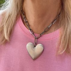 "Our large heart pendant necklace adds a modern touch, making it perfect for both casual and formal occasions. With a chunky paperclip link chain in silver, this silver heart necklace is sure to make a statement.  Finished with an adjustable lobster clasp so you can wear it as a choker or a little longer. This unique chunky necklace makes for a special gift for Valentine's Day, Mother's Day, Anniversaries, or any significant occasion. Details * Material: Silver-plated stainless steel chain. Wate Silver Heart Pendant Chain Necklace With Chunky Chain, Trendy Silver Heart Necklace With Lobster Clasp, Silver Heart Necklace With Chunky Chain, Trendy Silver Heart Necklace With Chunky Chain, Silver Heart-shaped Cable Chain Necklace, Silver Open Heart Chain Necklace With Charm, Silver Necklace With Chunky Chain For Valentine's Day, Valentine's Day Silver Heart Necklace With Chunky Chain, Silver Heart-shaped Paperclip Chain Jewelry