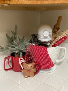 a cup filled with christmas items on top of a counter