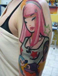 a woman with pink hair and tattoos on her arm