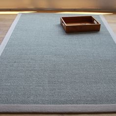 a wooden box sitting on top of a rug