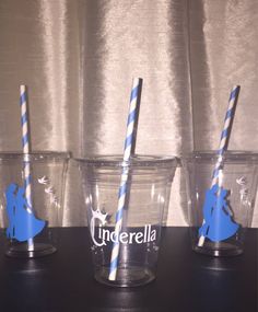 three clear cups with blue and white striped straws