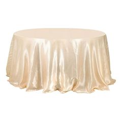 a round table with a white cloth on it's top and the skirt draped over