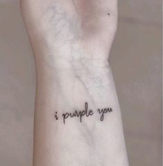 a woman's wrist with the words i purple you tattooed on her left arm