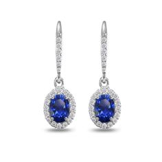 These stunning earrings feature 7x5mm created blue sapphire gemstones delightfully set into highly polished sterling silver and are adorned with a sparkling halo white topaz border. These elegant and unique earrings are crafted of sterling silver and are secured by lever-backs. Product Details Metal Type sterling-silver Metal Stamp 925-sterling Weight 3.3GR Length 27MM Width 8MM Back Finding lever-back Stone Details Gem Type created-sapphire Number of Stones 2 Stone Color blue Stone Shape oval-s Cubic Zirconia Dangle Earrings With Birthstone, Sapphire Birthstone Earrings, Turquoise Heart, Heart Drop Earrings, Leverback Earrings, Citrine Gemstone, Stunning Earrings, Lovely Earrings, Sapphire Gemstone