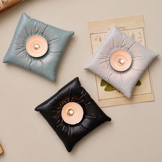 three decorative pillows with buttons on them