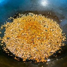 a frying pan filled with food cooking on top of a stove