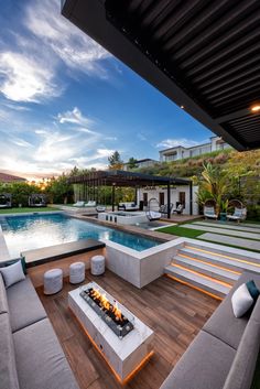 a fire pit sitting on top of a wooden deck next to a swimming pool