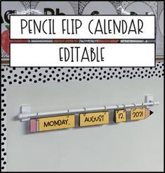 a calendar is hanging on the wall in front of a sign that says pencil flip calendar editable