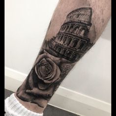 a man's leg with a black and white photo of the leaning tower of pisa