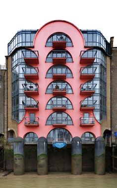 the building is pink and has balconies on it's sides as well