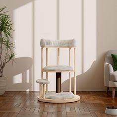 a white chair sitting on top of a wooden floor next to a potted plant