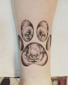 a dog's paw with three dogs on it and one is black and white