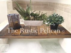 the rustic pelican logo is displayed on a table with succulents