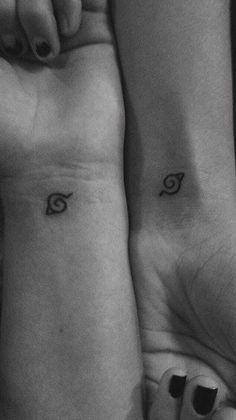 two people with matching tattoos on their arms