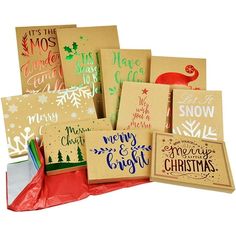 christmas greeting cards and envelopes in brown paper with hand lettering on the front, set against a white background