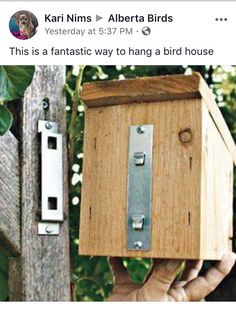 a person holding up a wooden box with metal latches on it's sides