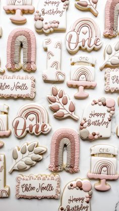 decorated cookies with pink and white icing on a table