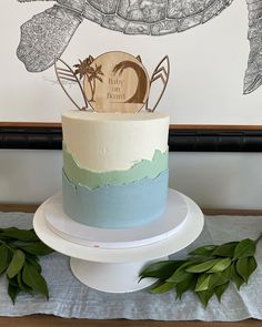 the cake is decorated with an image of a turtle and palm tree on it's top