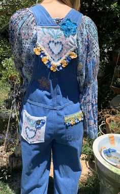 These adorable overalls are truly vintage, I remember the Bum brand in the 1970's as being one of the cool brands to have. These are a size small, but because overalls are designed to fit loosely and can be adjusted in a variety of ways (straps, buttons on the side, etc.) I would estimate these could fit a tall size 4 up to a size 10 in women's sizes. The pocket of the bib I added vintage embroidered linen of flowers and leaves. At the top of the bib, there was a logo that I didn't like so I put Bohemian Patchwork Overalls For Spring, Bohemian Overalls With Pockets For Festivals, Casual Cotton Overalls For Festivals, Bohemian Cotton Overalls For Spring, Bohemian Style Overalls For Festival, Vintage Bib Front Shortalls For Spring, Hippie Summer Overalls With Pockets, Bohemian Overalls With Pockets For Spring, Vintage Bib Front Overalls For Summer