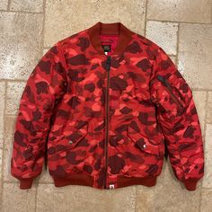 Bape Red Camo Ma-1 Bomber Jacket Size Medium Great Condition Measurements: Chest: 21” Length: 27.75” Sleeve Length: 26.5” Shoulders: 18.25” Red Military Long Sleeve Outerwear, Fitted Red Outerwear For Streetwear, Urban Red Outerwear For Outdoor, Red Urban Outerwear For Outdoor, Red Winter Streetwear Outerwear, Red Winter Outerwear For Streetwear, Urban Red Outerwear With Pockets, Bape Jacket, Red Camo