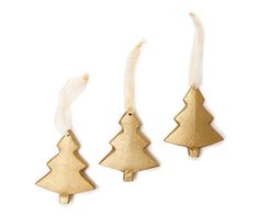 three gold christmas trees hanging from strings