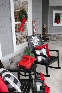 the front porch is decorated for christmas with red and black decorations