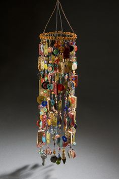 a wind chime with lots of different colored beads hanging from it's sides