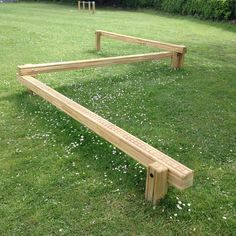 a wooden bench sitting on top of a lush green field