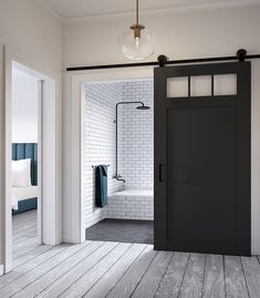 an open door leading to a bathroom with white brick walls and wood flooring in the background