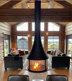 a living room filled with furniture and a fire place in the middle of a room