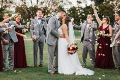 a bride and groom are surrounded by their wedding party