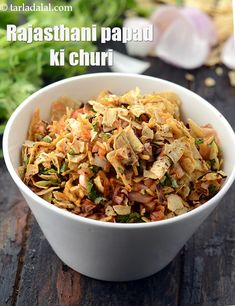 a white bowl filled with food on top of a wooden table