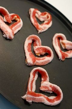 bacon shaped into the shape of hearts on a pan