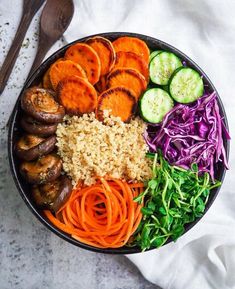 a bowl filled with carrots, cucumbers, and other veggies