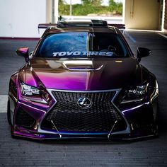 the front end of a purple and black car