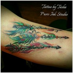 a tattoo on the arm of a woman with an arrow and feathers in different colors