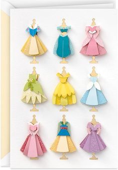 a card with paper cut outs of princess dresses on it's front and back sides