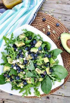 a salad with blueberries and avocado on a plate