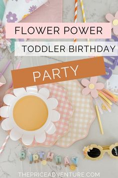 a flower power toddler birthday party with paper flowers, plates and napkins on the table